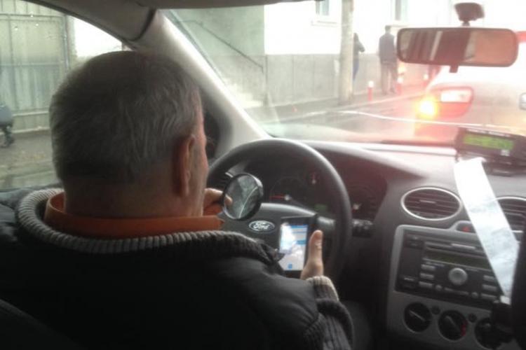Acest șofer de taxi citește mesaje în timp ce conduce! Șocant e altceva - FOTO