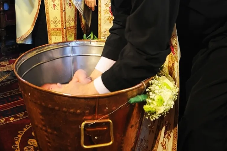 Bebeluș în stop-cardiorespirator după ce preotul l-a scufundat în cristelniță