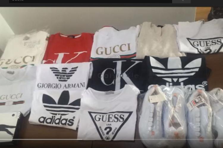 Percheziții făcute la Cluj și sute de haine contrafăcute au fost confiscate din magazine - FOTO