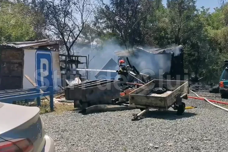 VIDEO Incendiu cu risc major într-o parcare din Cluj, vis-a-vis de Vamă. Focul, izbucnit la o anexă, s-a extins la un camion și amenința mașinile din jur