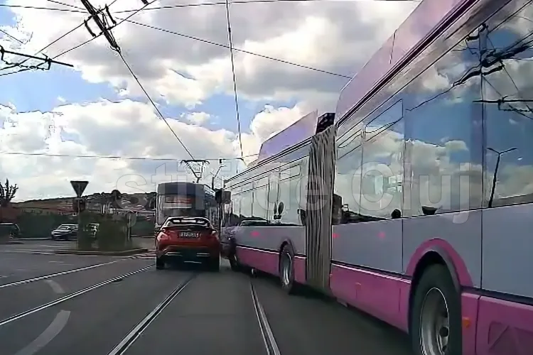 VIDEO. Șofer aproape făcut „acordeon” la Cluj, între tramvai și troleu, în zona Auchan Iris. A scăpat ca prin urechile acului: „Sigur i-a înghețat inima”