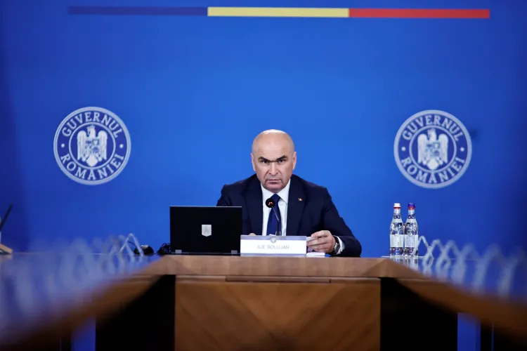 Șoc în coaliție! Bolojan amenință cu demisia după 5 ore de negocieri, tăierile din administrația locală amânate până pe 15 septembrie