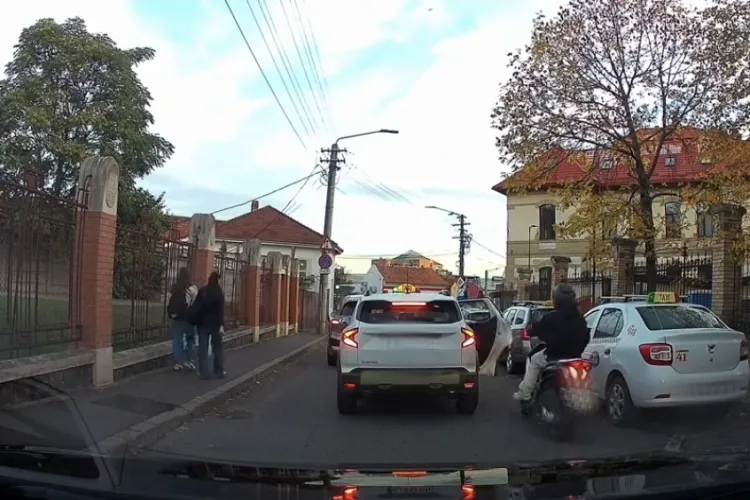 VIDEO. Ghinion teribil pentru un motociclist, la Cluj! O portieră deschisă de un taxi în trafic l-a trântit printre mașini